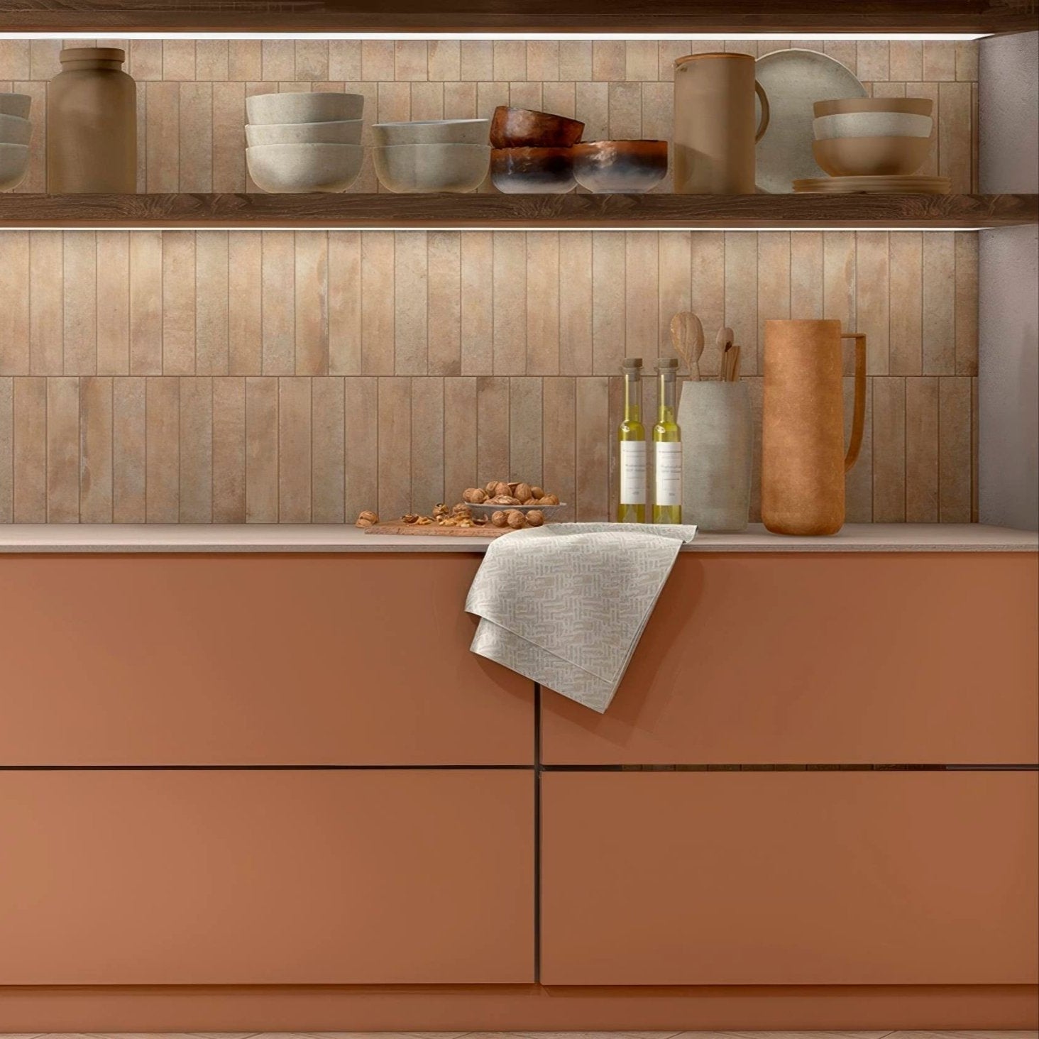 A light gray textured kitchen towel with a subtle woven pattern draped over a terracotta ochre porcelain cabinet edge