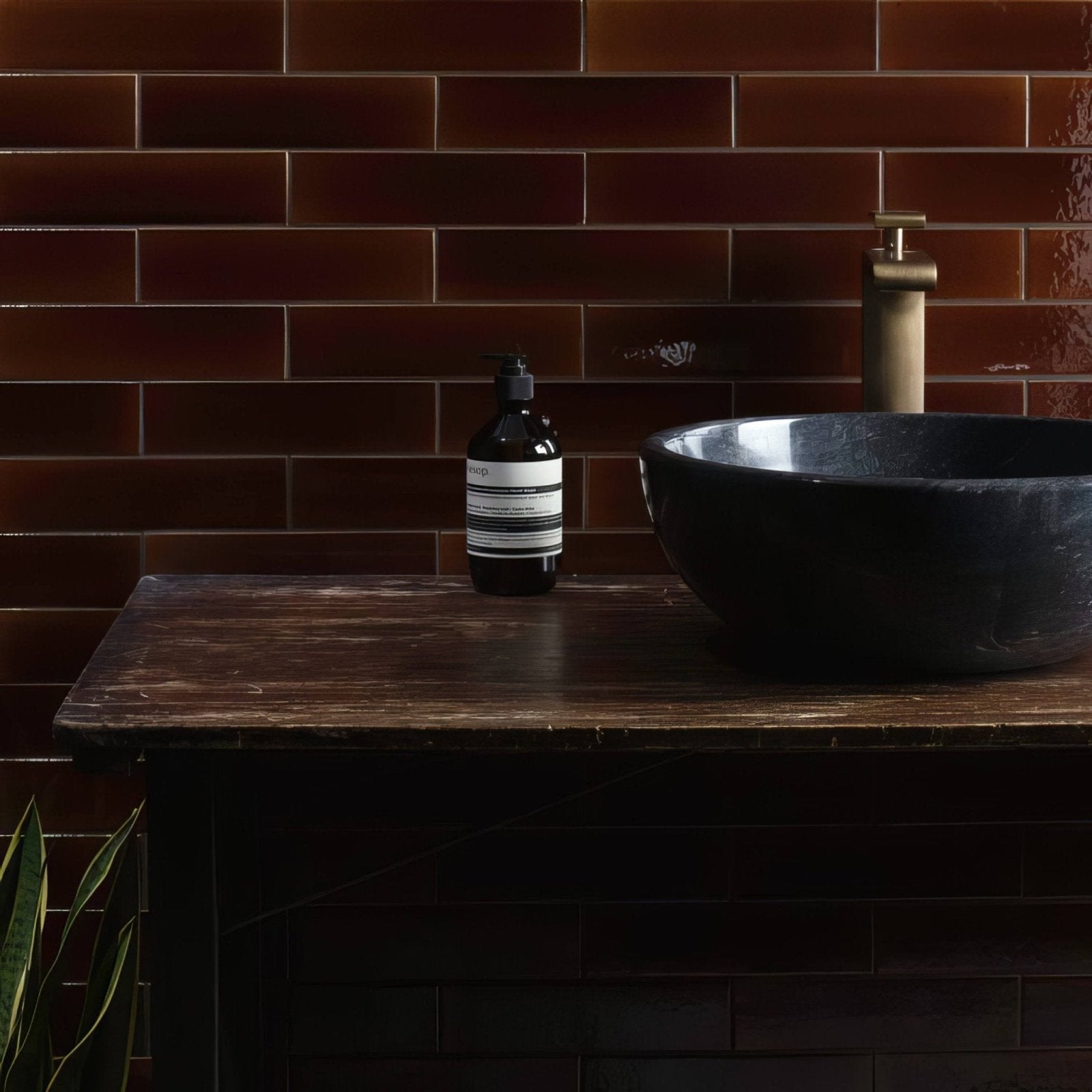Dark amber glass bottle with black pump and minimalist white aesop label in tor brick tile design