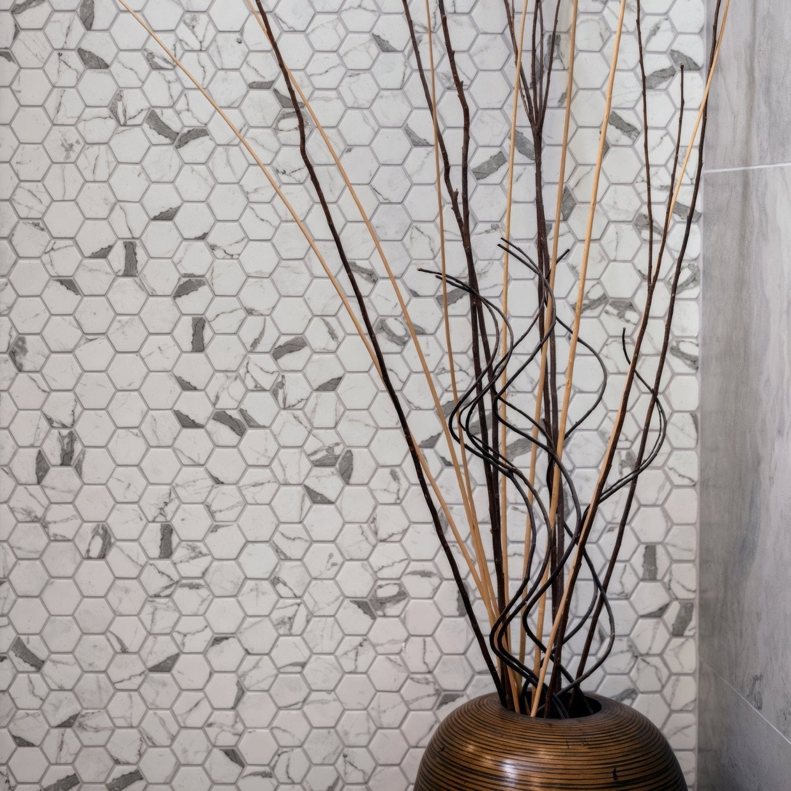 Torcello White Hexagon white hexagonal mosaic with a woven bamboo vase of dried branches
