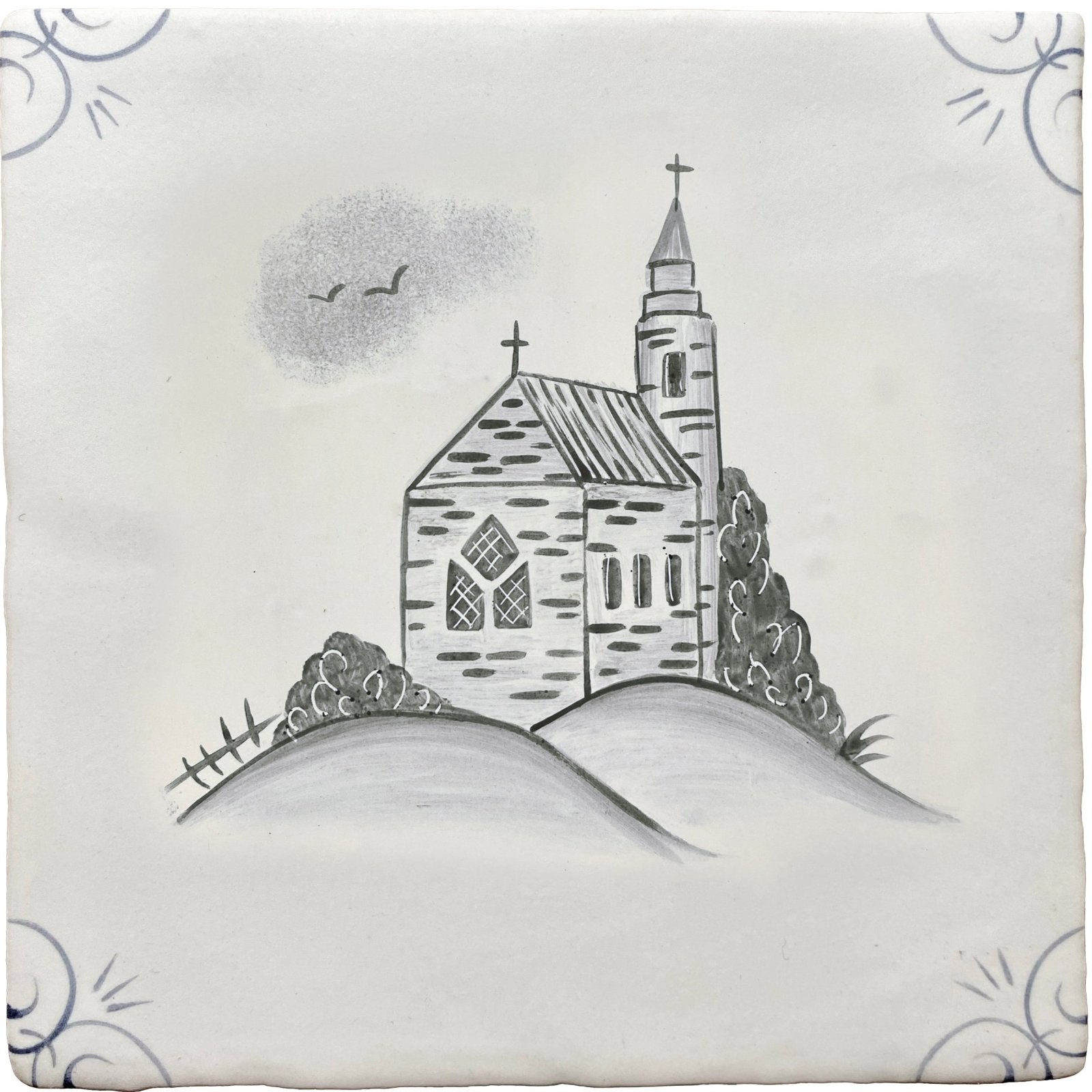 White ceramic tile with hand-painted black and gray traditional english delft church illustration on a hill