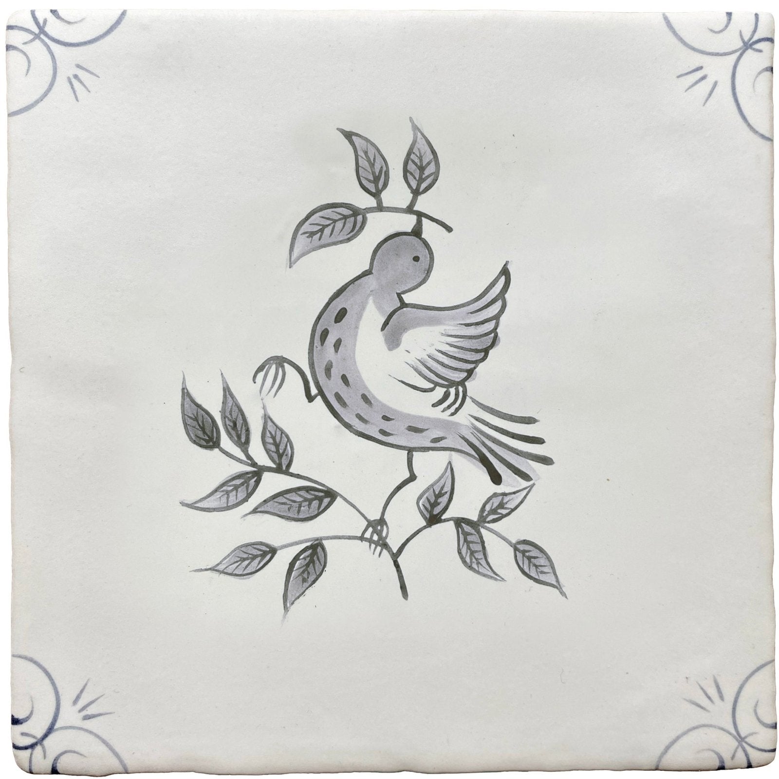 A square white ceramic tile with a hand-painted black and gray traditional English Delft dove on a branch