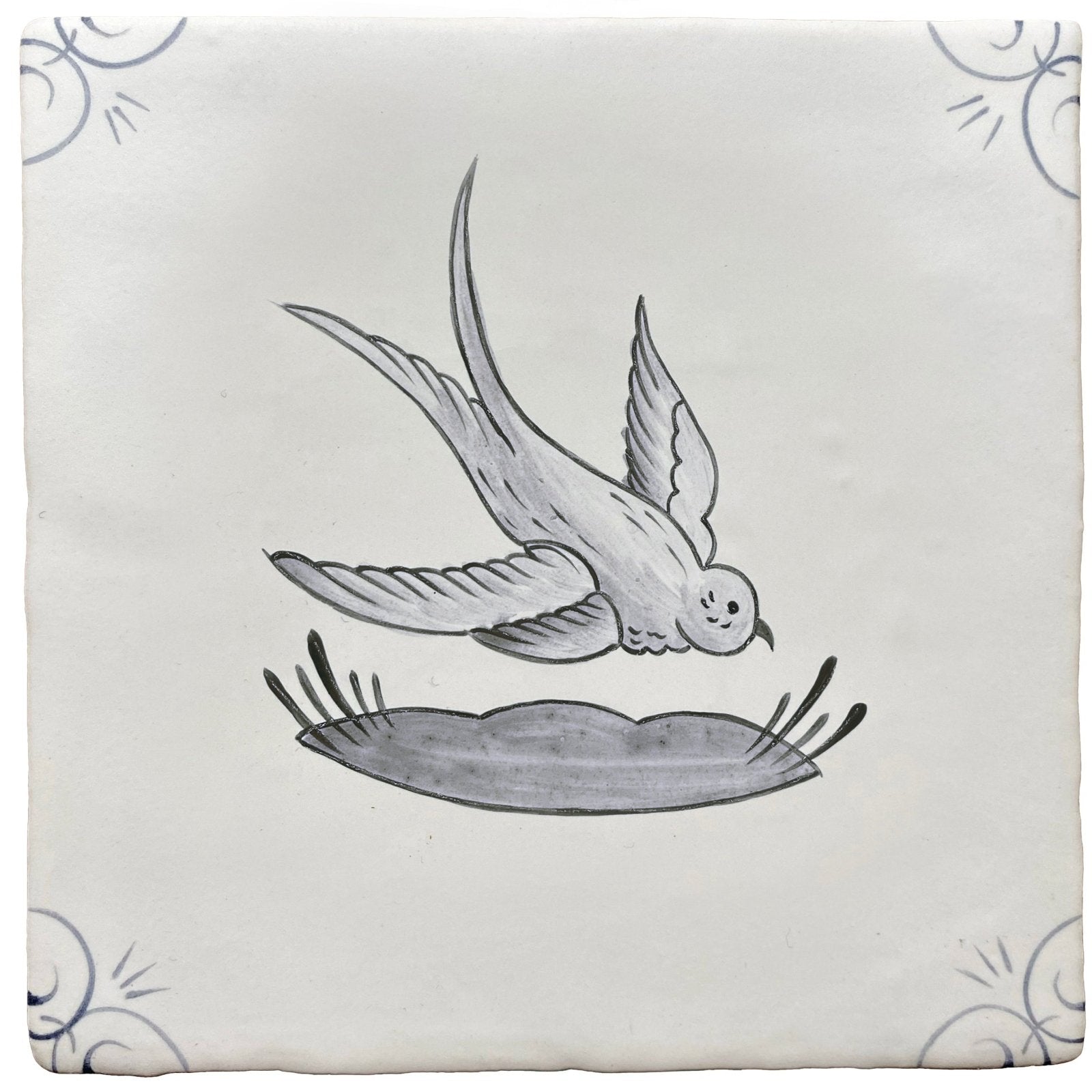 White ceramic tile with hand-painted black and gray swallow in flight above nest and decorative corner swirls traditional english delft