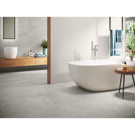 Trevi 1817 Silver Matt grey stone-effect tiles with a freestanding bathtub