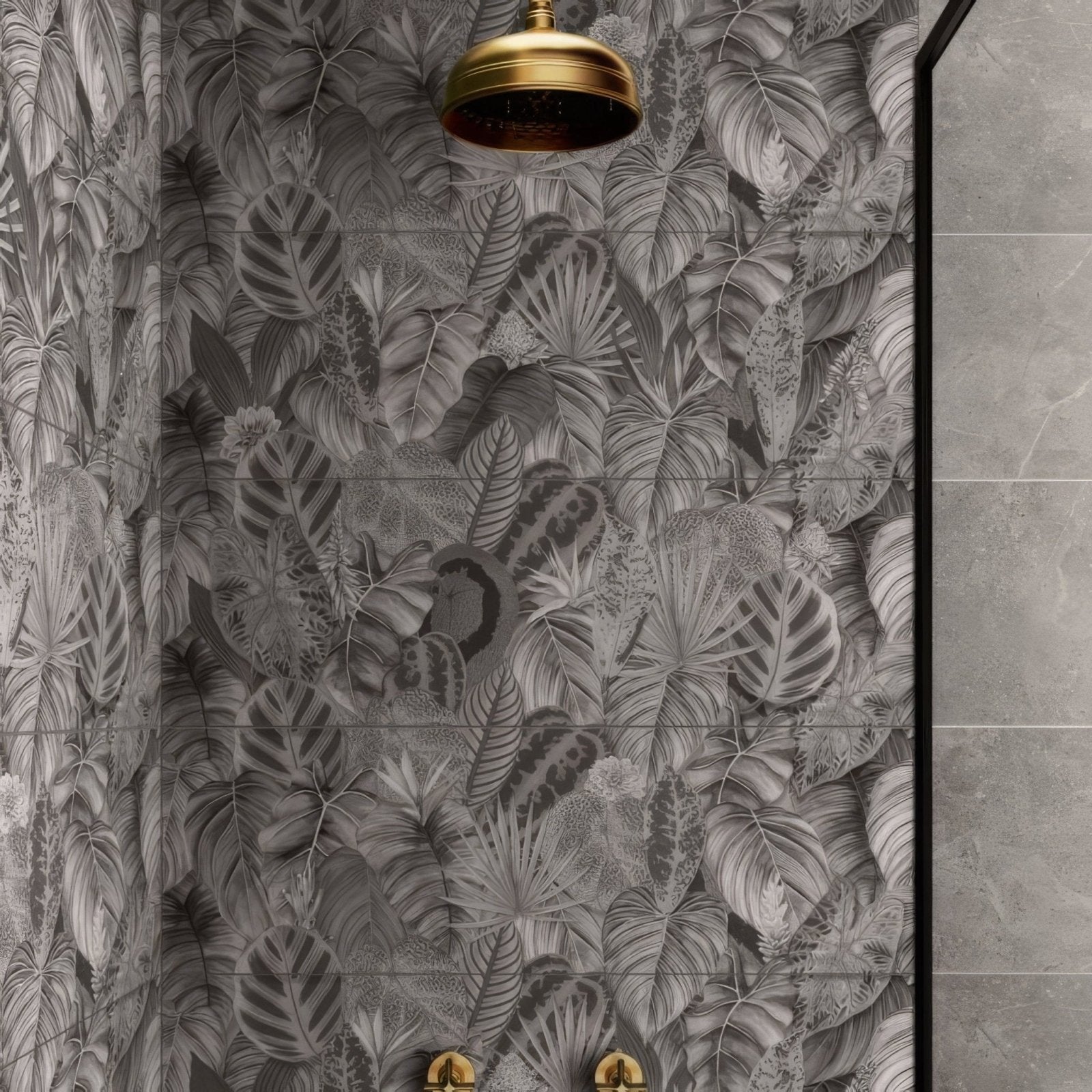 Gold-toned classic rounded showerhead mounted above gray tropical leaf patterned tile from tropical oasis monochrome single tile