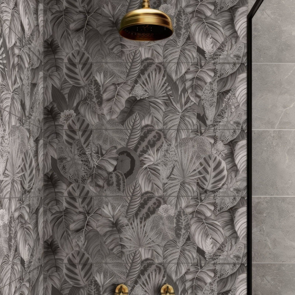 Gold-toned classic rounded showerhead mounted above gray tropical leaf patterned tile from tropical oasis monochrome single tile