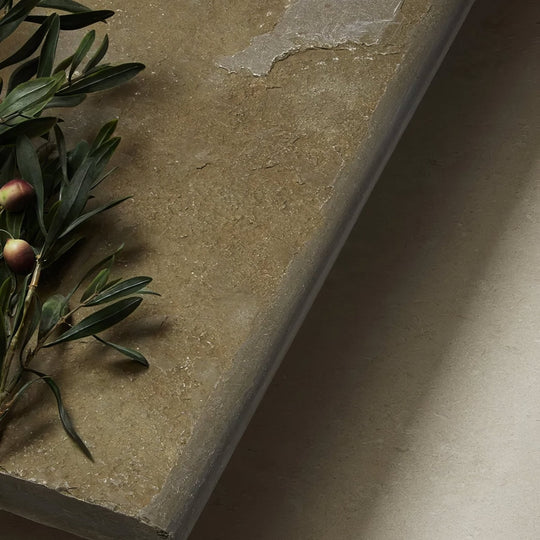 Beige trusloe limestone seasoned bullnose coping with a textured natural surface and subtle veining stone slab