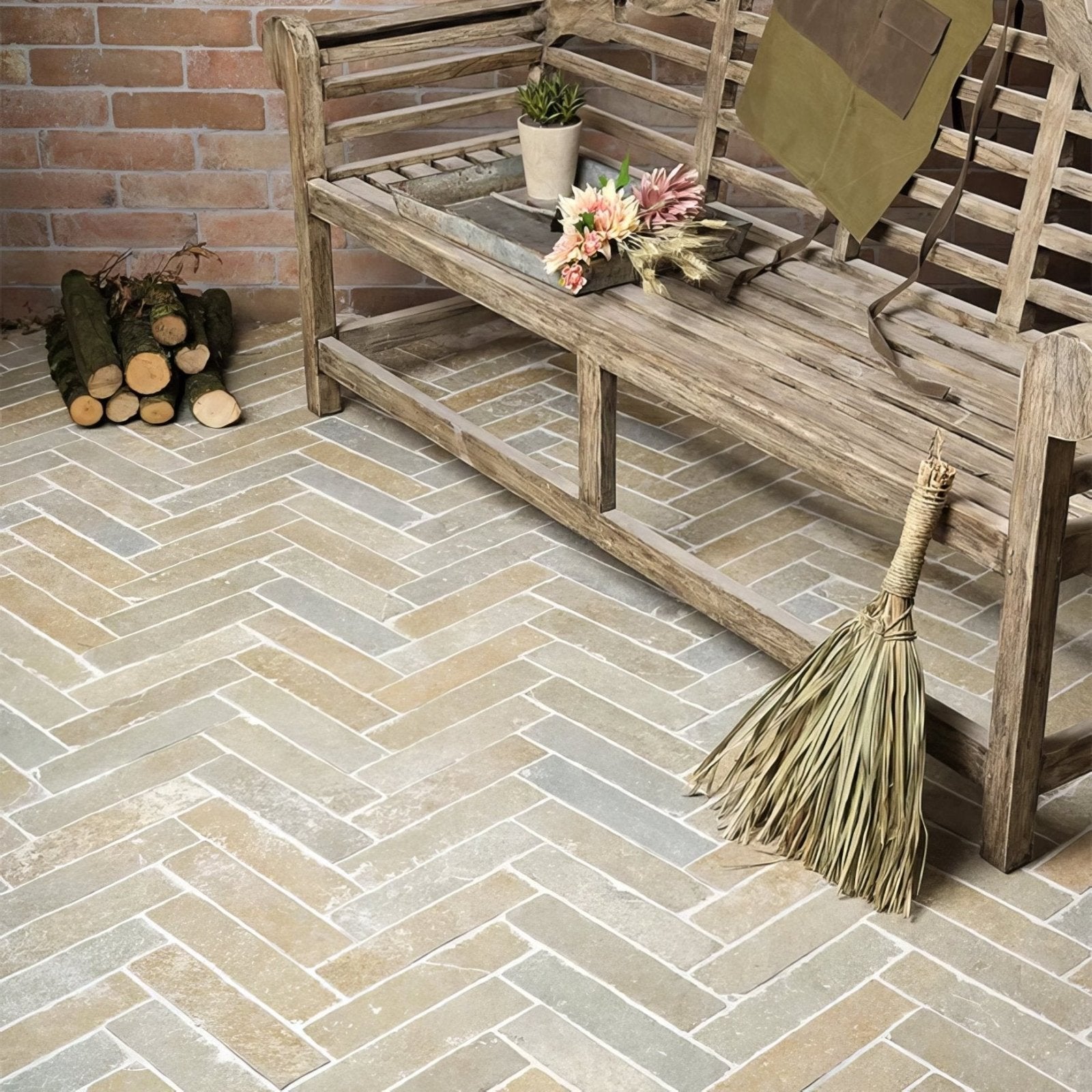 Weathered wooden bench with rustic slats and woven straw broom against trusloe limestone seasoned finish parquet floor