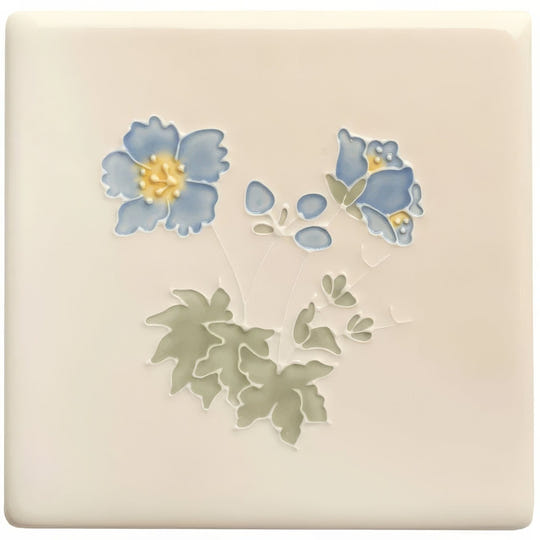 Cream-colored ceramic tile from tubelined floral collection meadow cranesbill with raised blue flowers yellow centers and green leaves