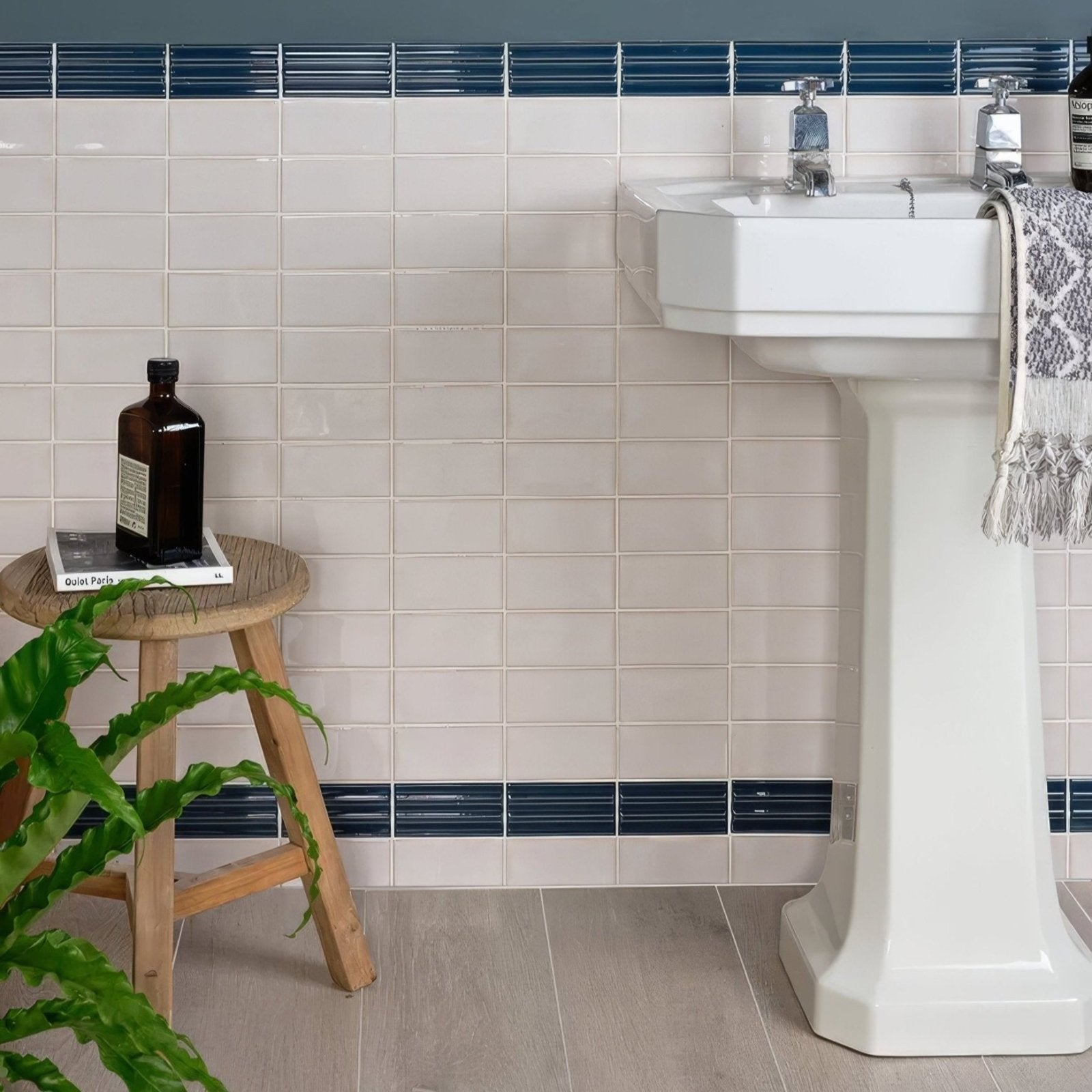 White ceramic pedestal sink with chrome faucet and matching soap dispenser from tunstall ceramic brick deep white series