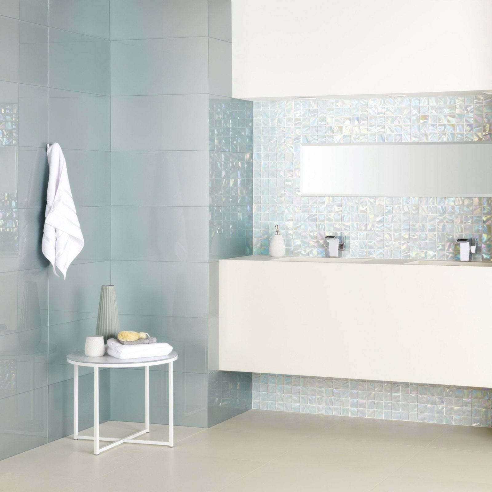 The bathroom features light blue glossy tiles with a subtle textured finish in Ultimo Shell Iridescent Mosaic