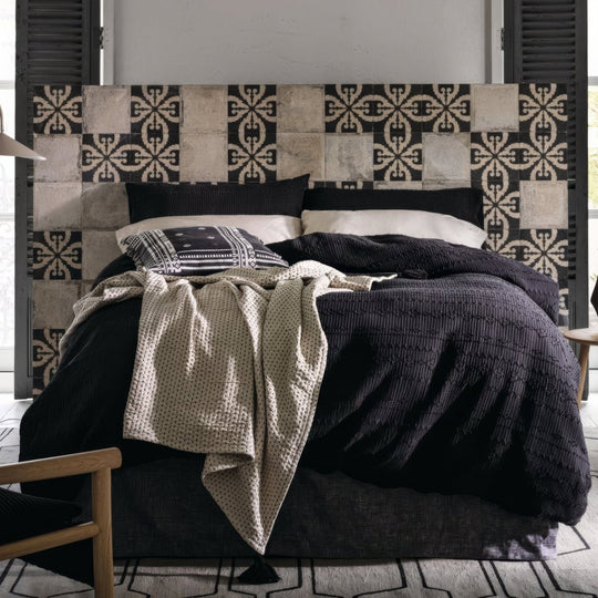 Black and white patterned porcelain tile headboard with a textured rustic finish from Urban Velasco collection