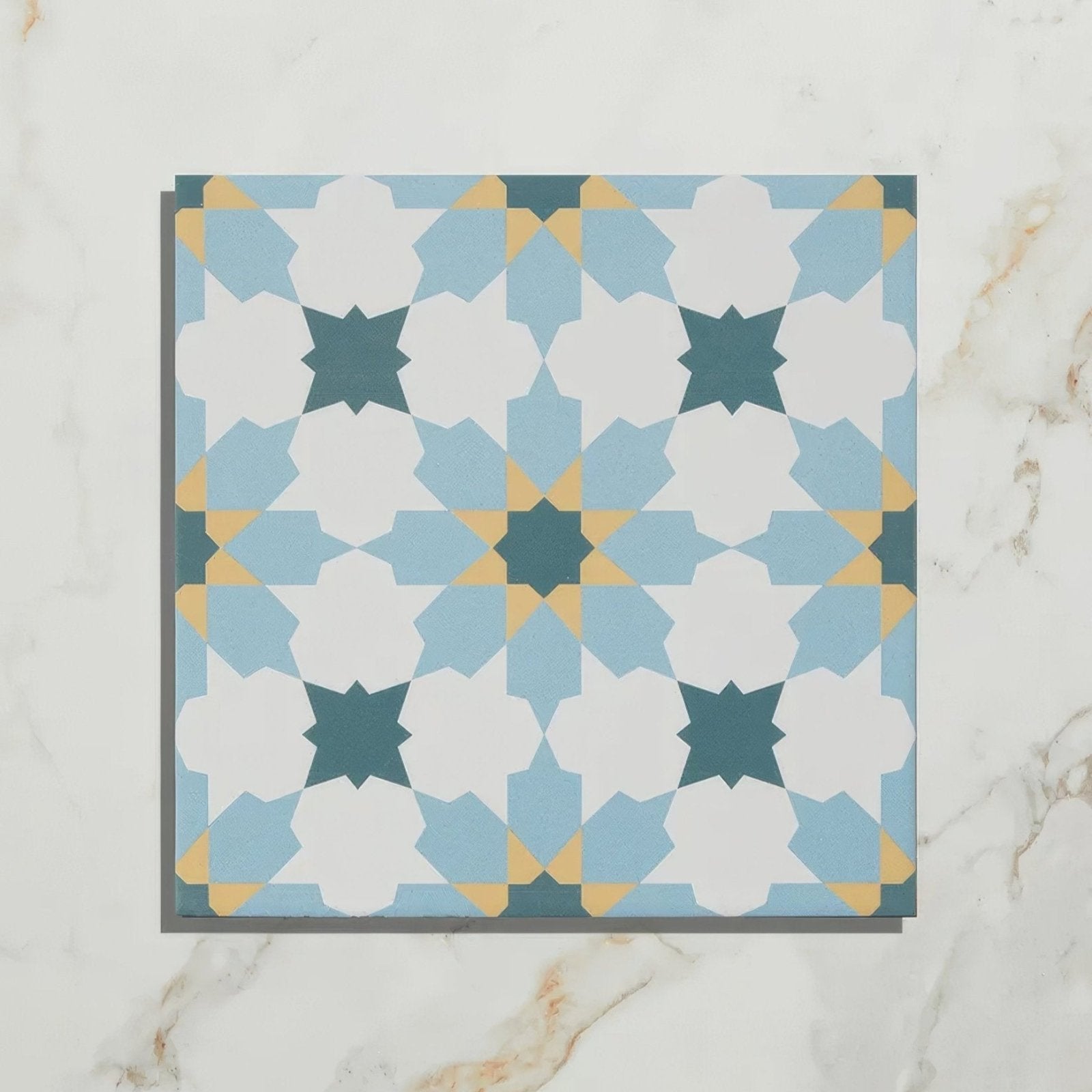 A square ceramic tile with a geometric pattern in light blue white and mustard yellow vacation porcelain tangier