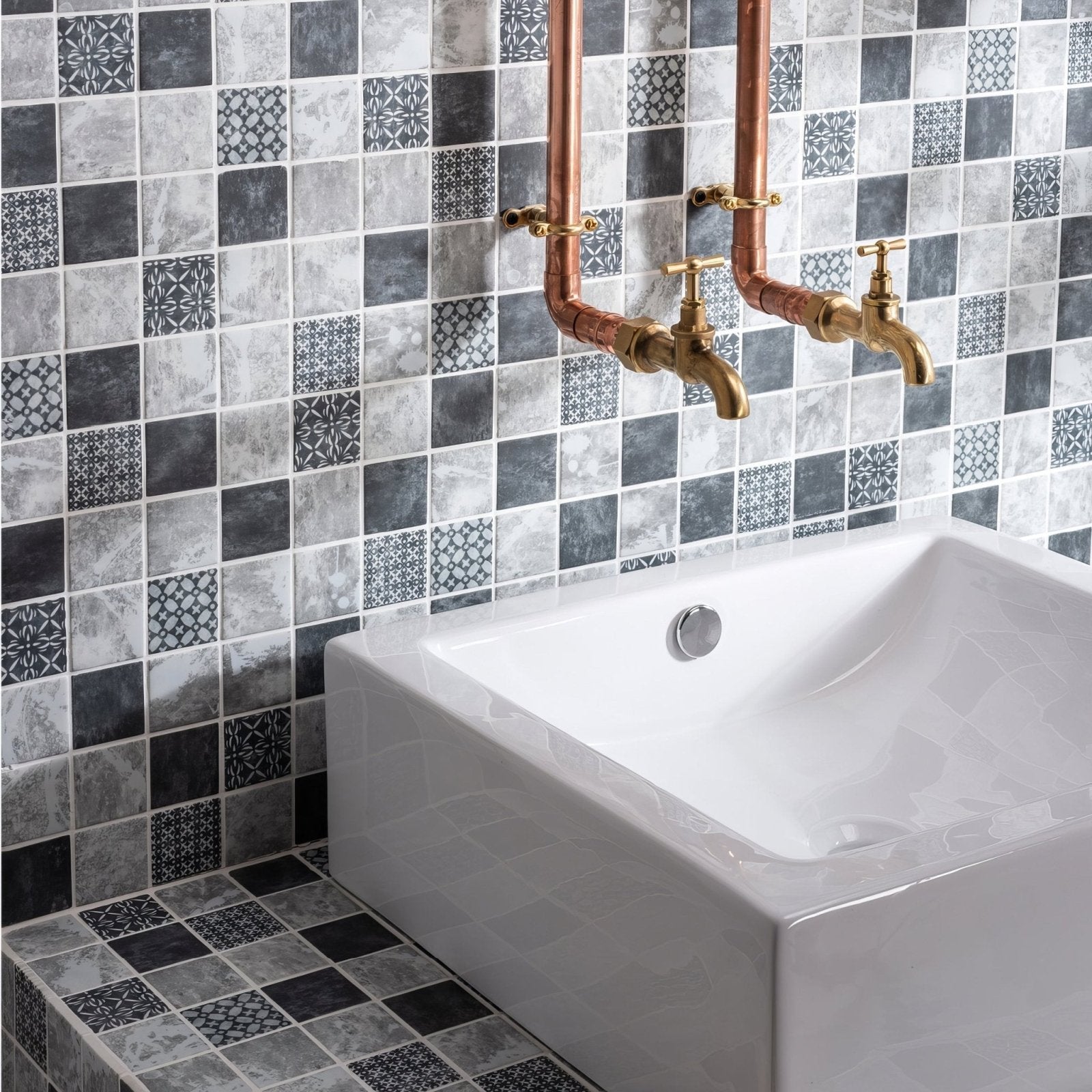 Venetia Glass Mosaic grey and black glass mosaic with a white ceramic sink and copper pipes