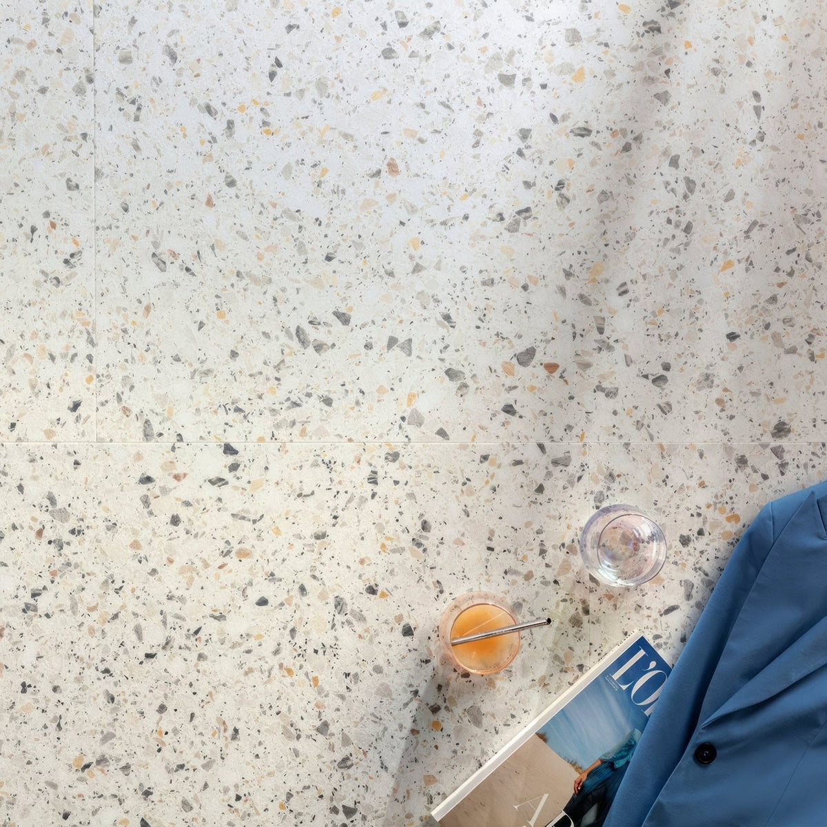 Verona f523 terrazzo small vinyl tiles with speckled gray black and beige fragments on a light background