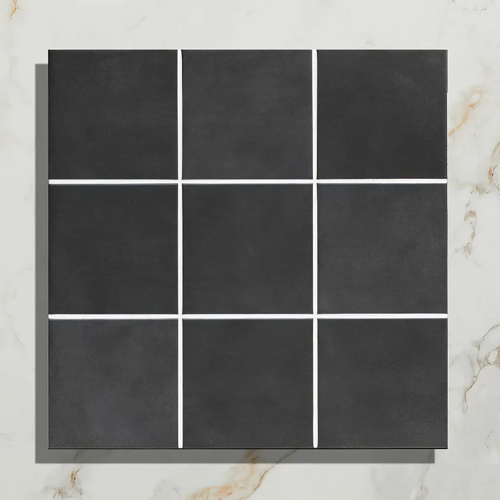 Nine square victorian style porcelain anthracite field tiles in black matte with white grout lines arranged in a grid