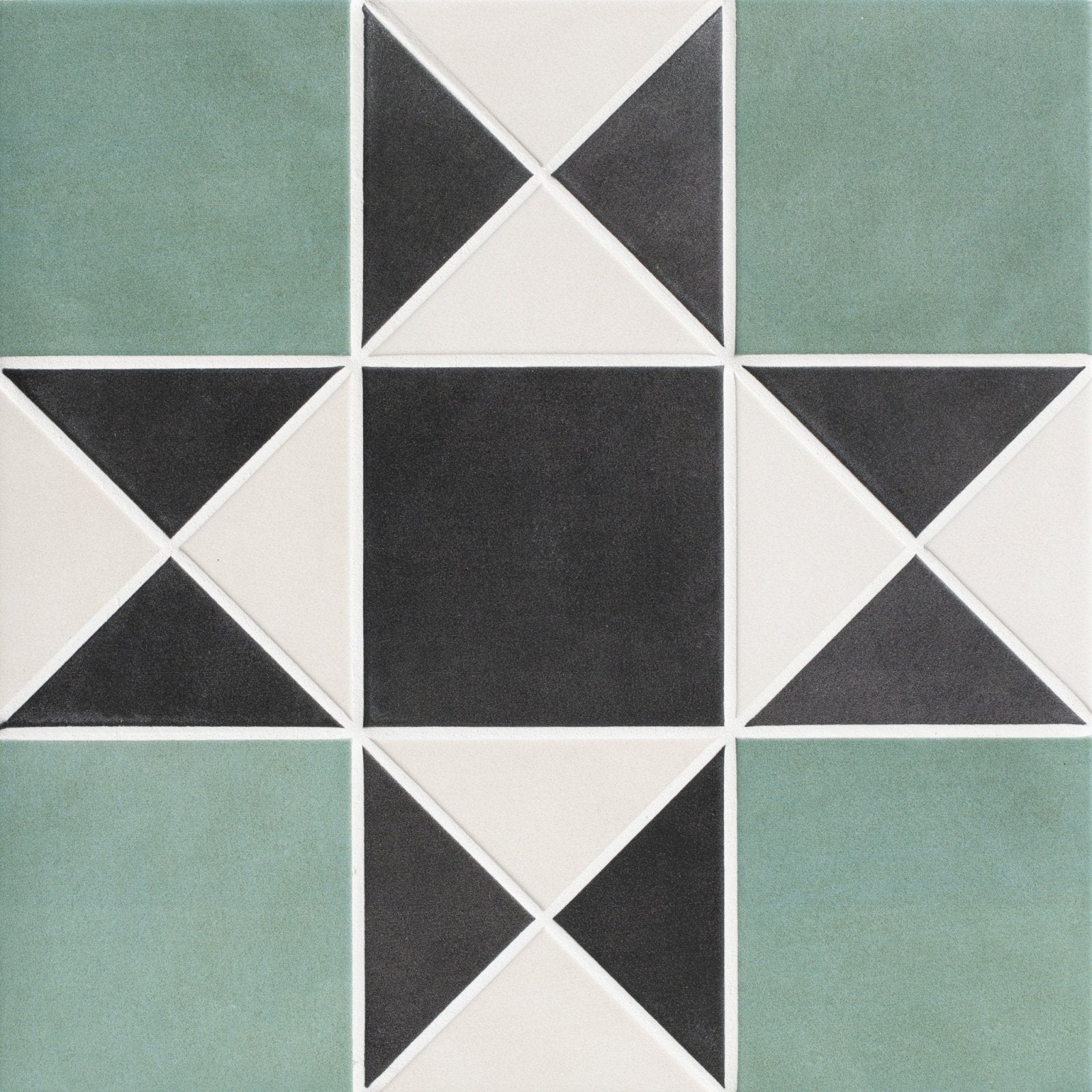 Geometric mosaic tile with central black square and white dark gray triangles on forest green porcelain background