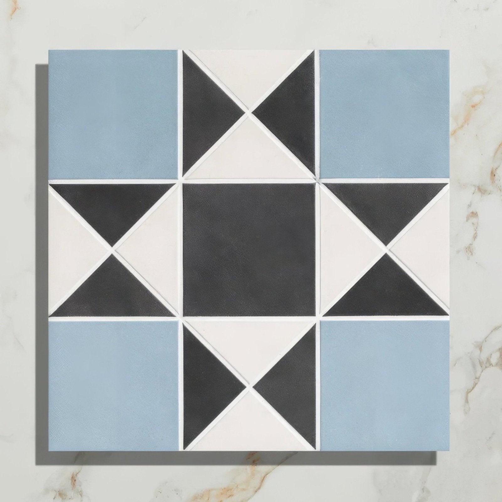 Victorian style porcelain tile featuring a blue black and white star-like finchley pattern for decorative use