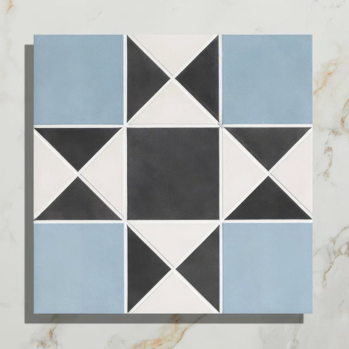 Victorian style porcelain tile featuring a blue black and white star-like finchley pattern for decorative use