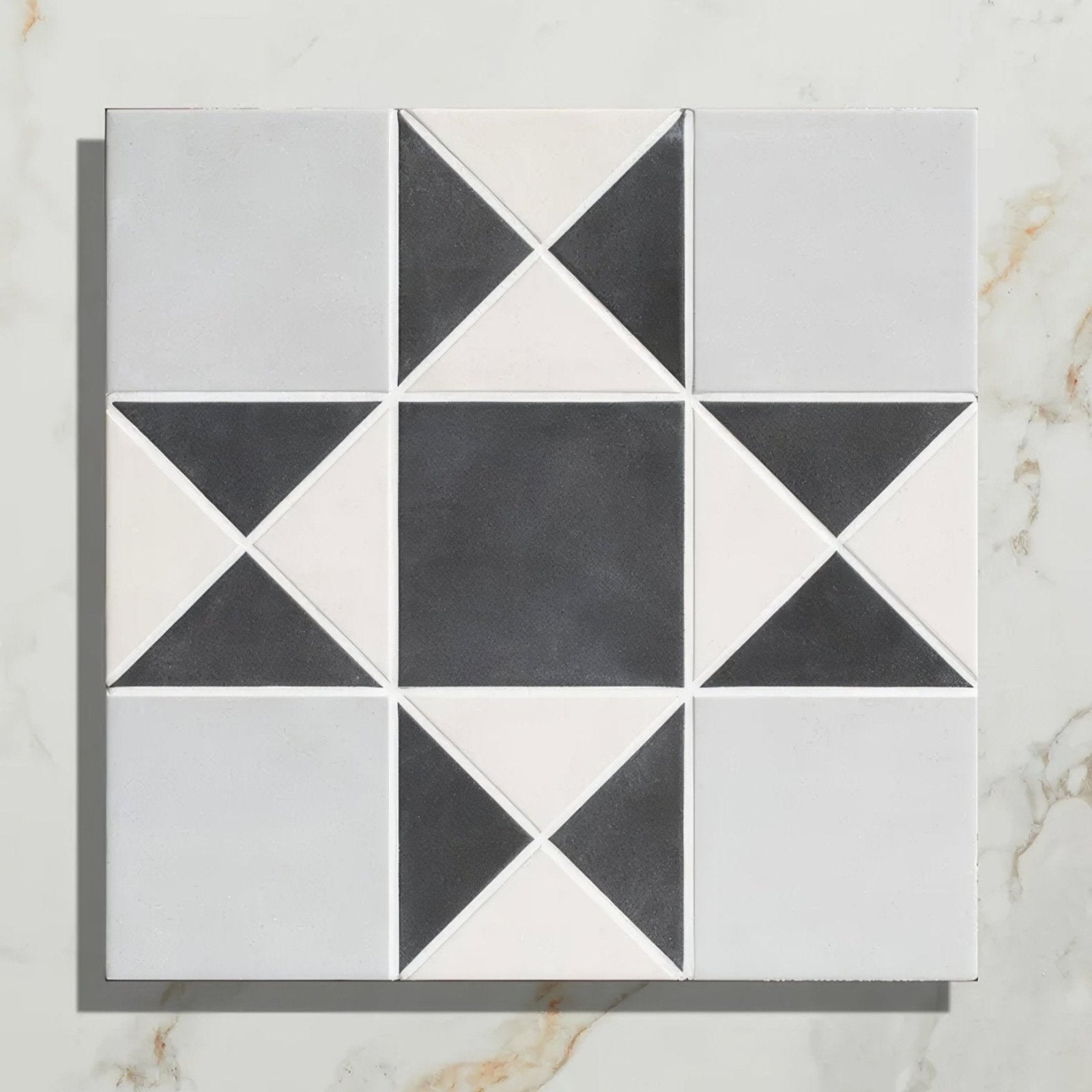 Black and white geometric starburst pattern on victorian style porcelain finchley pattern soft grey tile