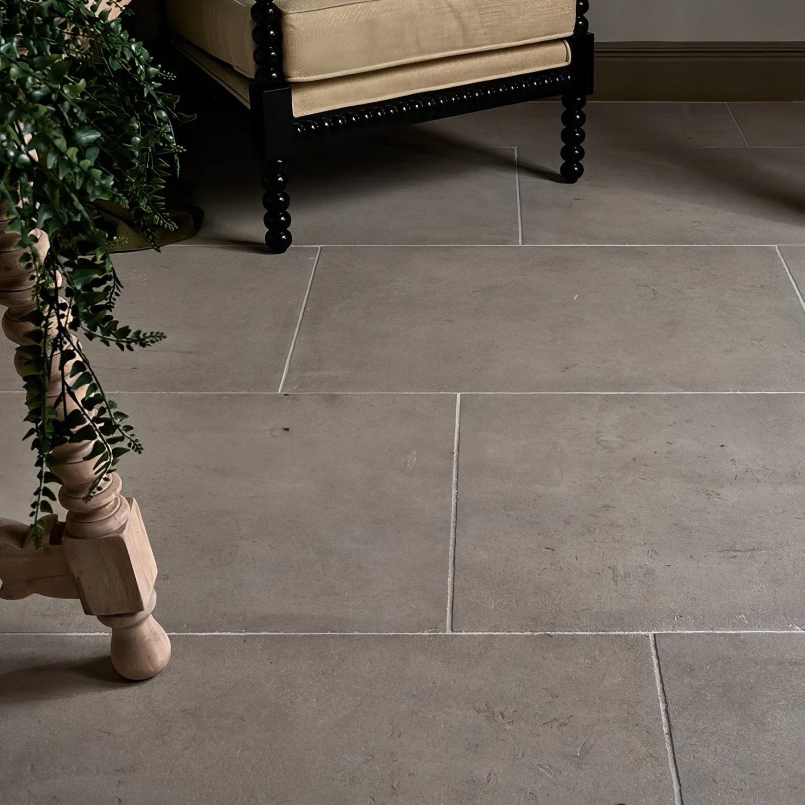 Gray stone tiles with subtle texture and natural variations laid in a grid pattern vienne limestone satino