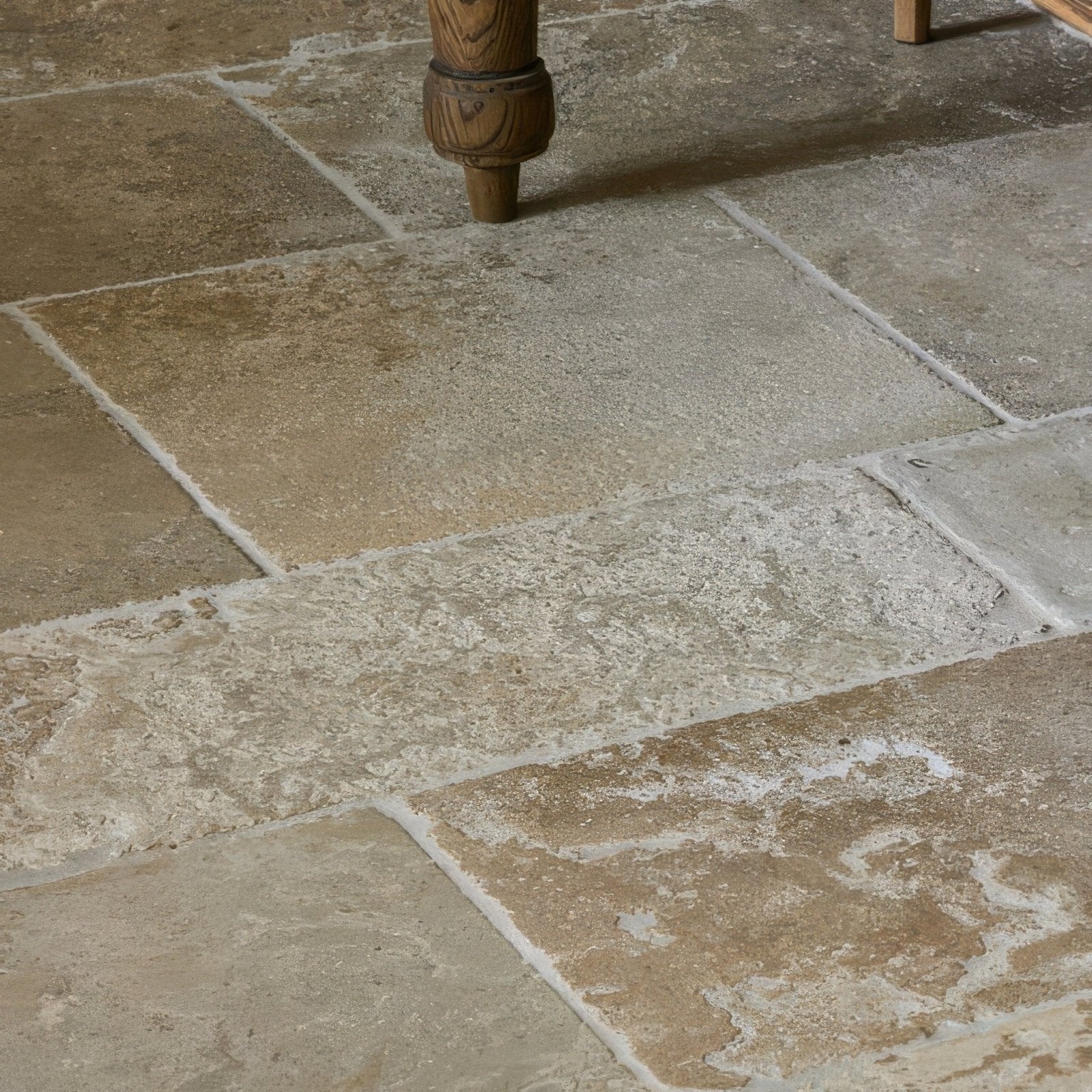 Beige and tan vieux bourgogne limestone floor tiles with a rustic textured ancient finish
