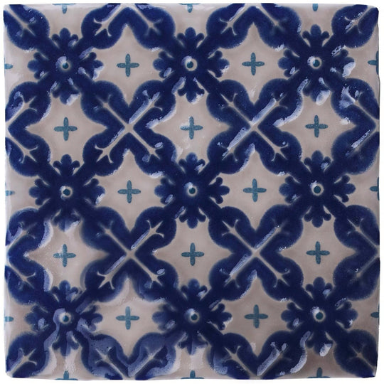 Blue and cream ceramic tile villette on truffle with intricate floral and cross patterns for decorative use
