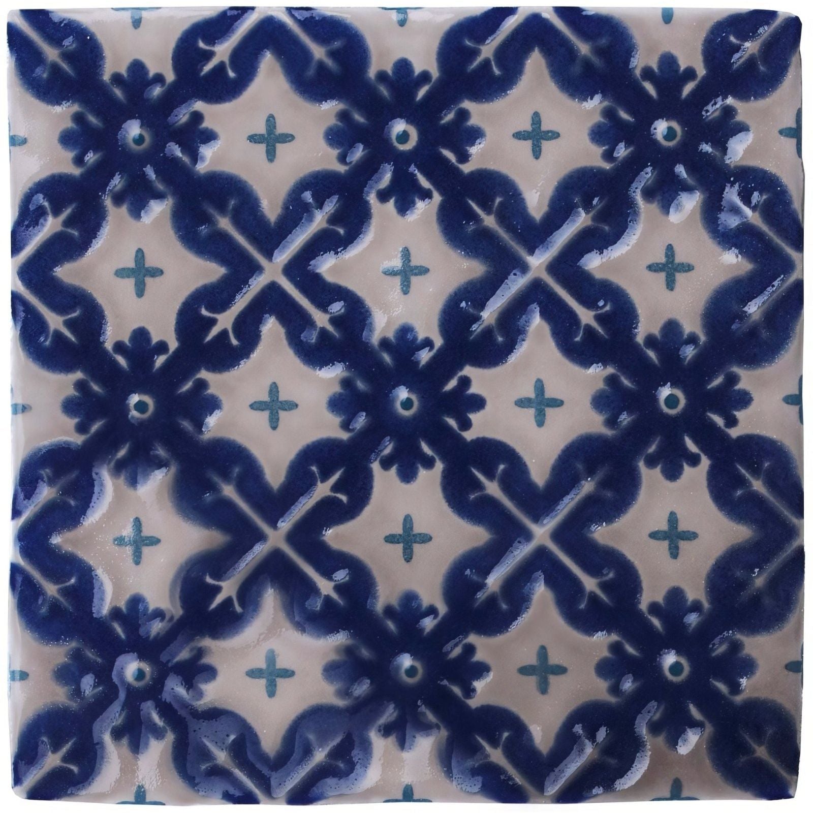 Blue and cream ceramic tile villette on truffle with intricate floral and cross patterns for decorative use
