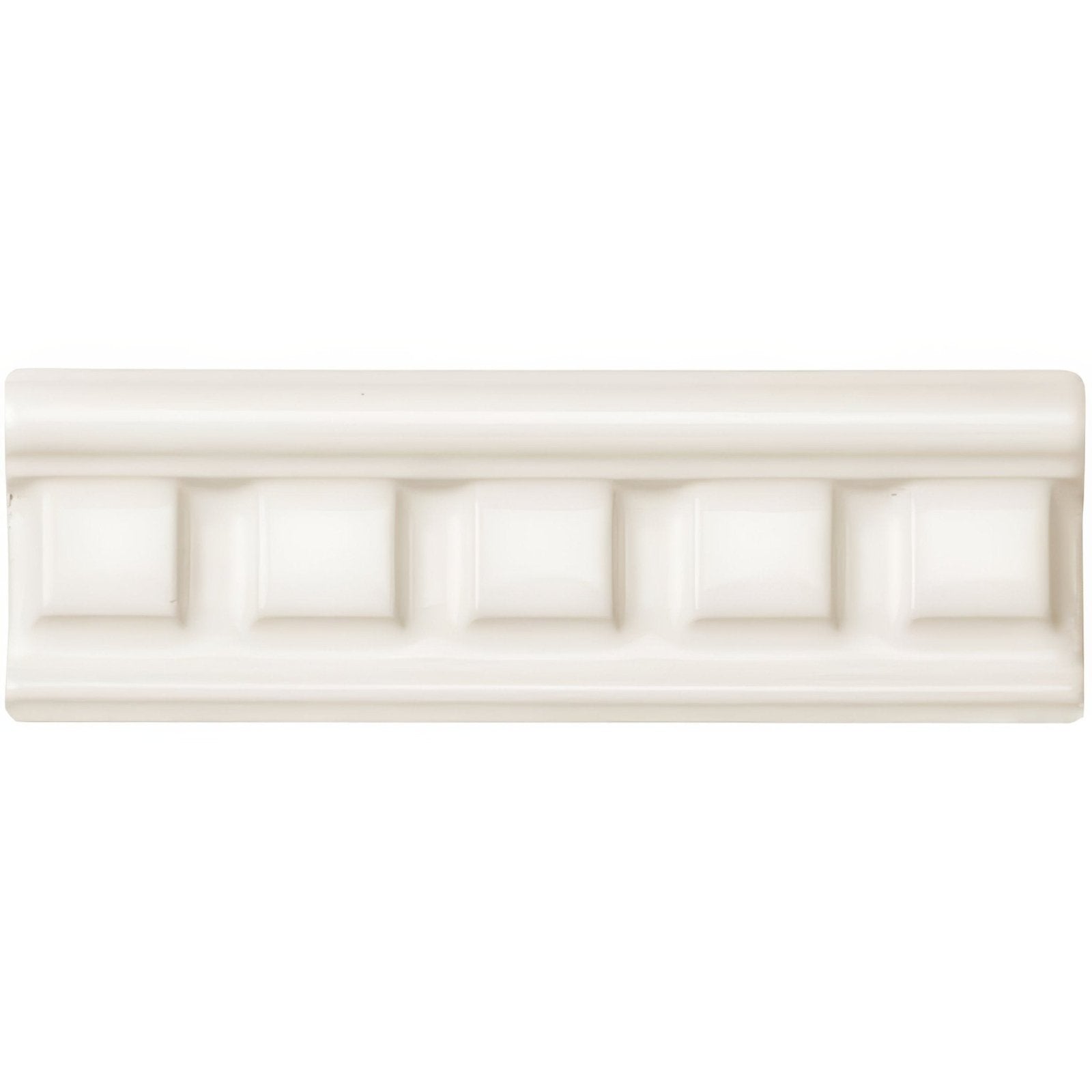 Cream-colored ceramic tile with a classic raised rectangular pattern in vintage white dentil moulding design