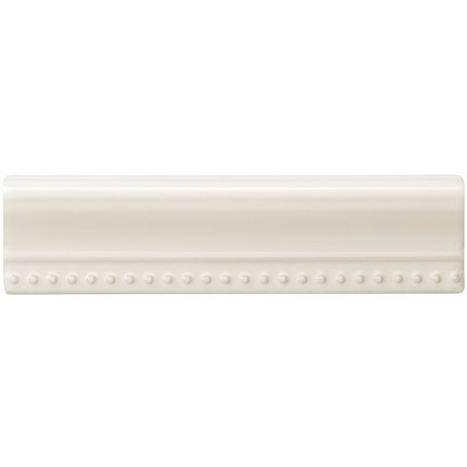 Cream-colored ceramic baseboard tile vintage white hogarth moulding with smooth glossy finish and beaded detailing