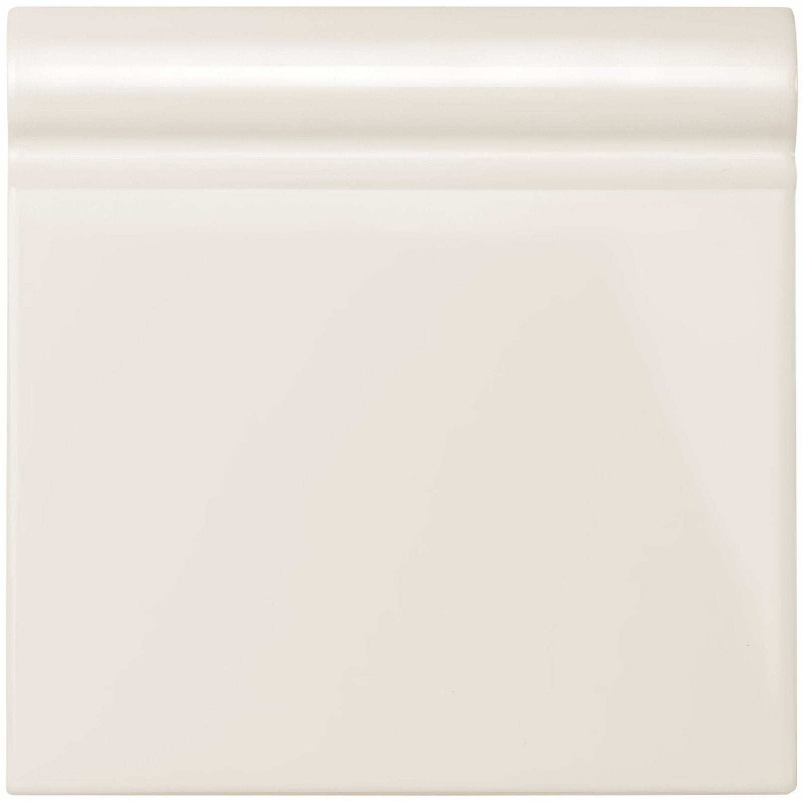 Vintage white skirting tile with cream-colored glossy ceramic baseboard and smooth rounded top edge for wall finishing