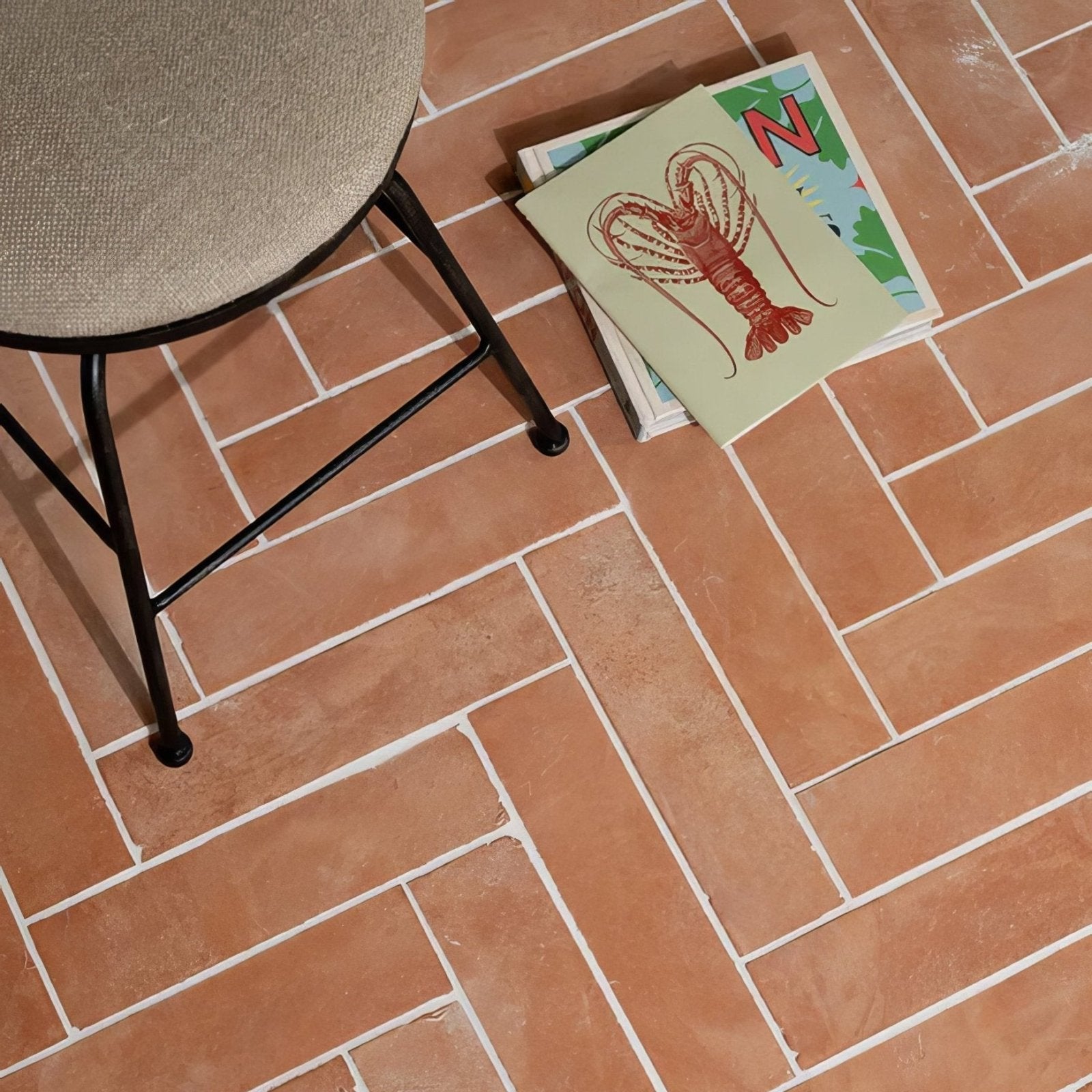 Wansdyke external terracotta floor tiles in rectangular shape arranged in a herringbone pattern with white grout lines