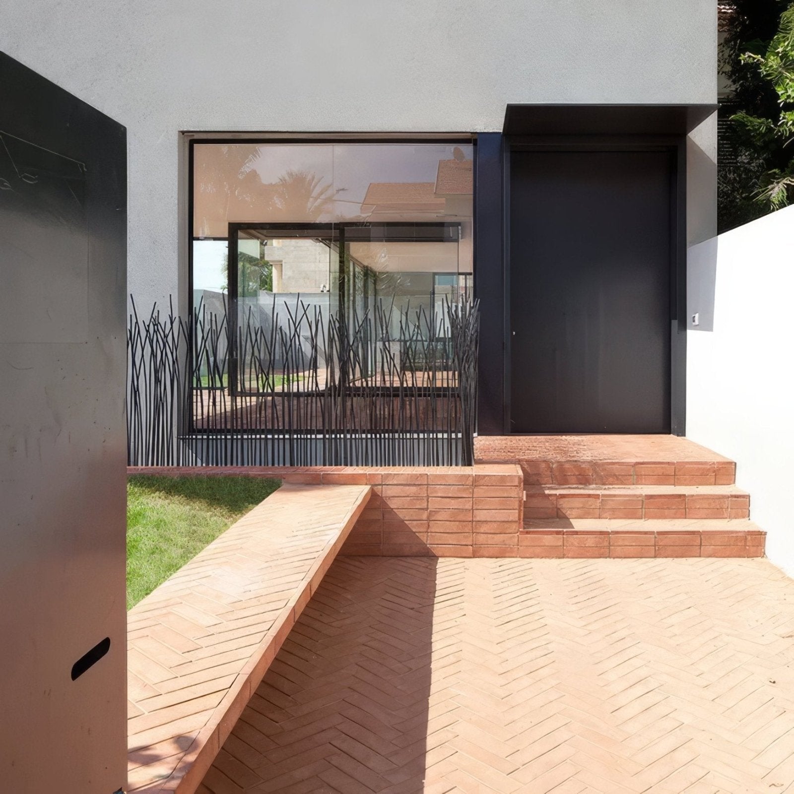 Black metal fence with slender vertical bars in a dense reed pattern for wansdyke external terracotta use