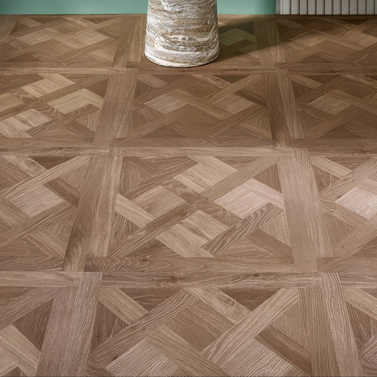 Brown wood-effect parquet floor tiles in herringbone pattern from warwick emrys oak design panel