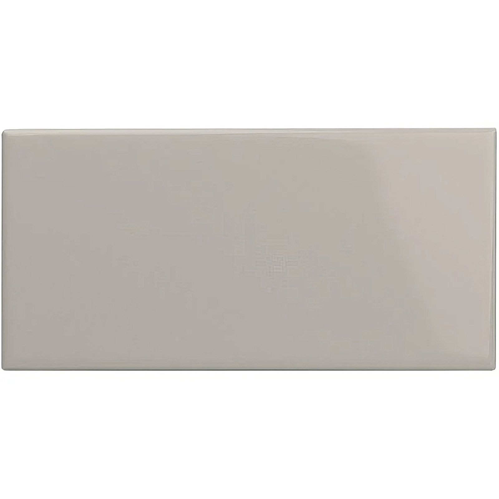 A sleek rectangular ceramic Westminster Grey Half Tile with a smooth glossy beige finish
