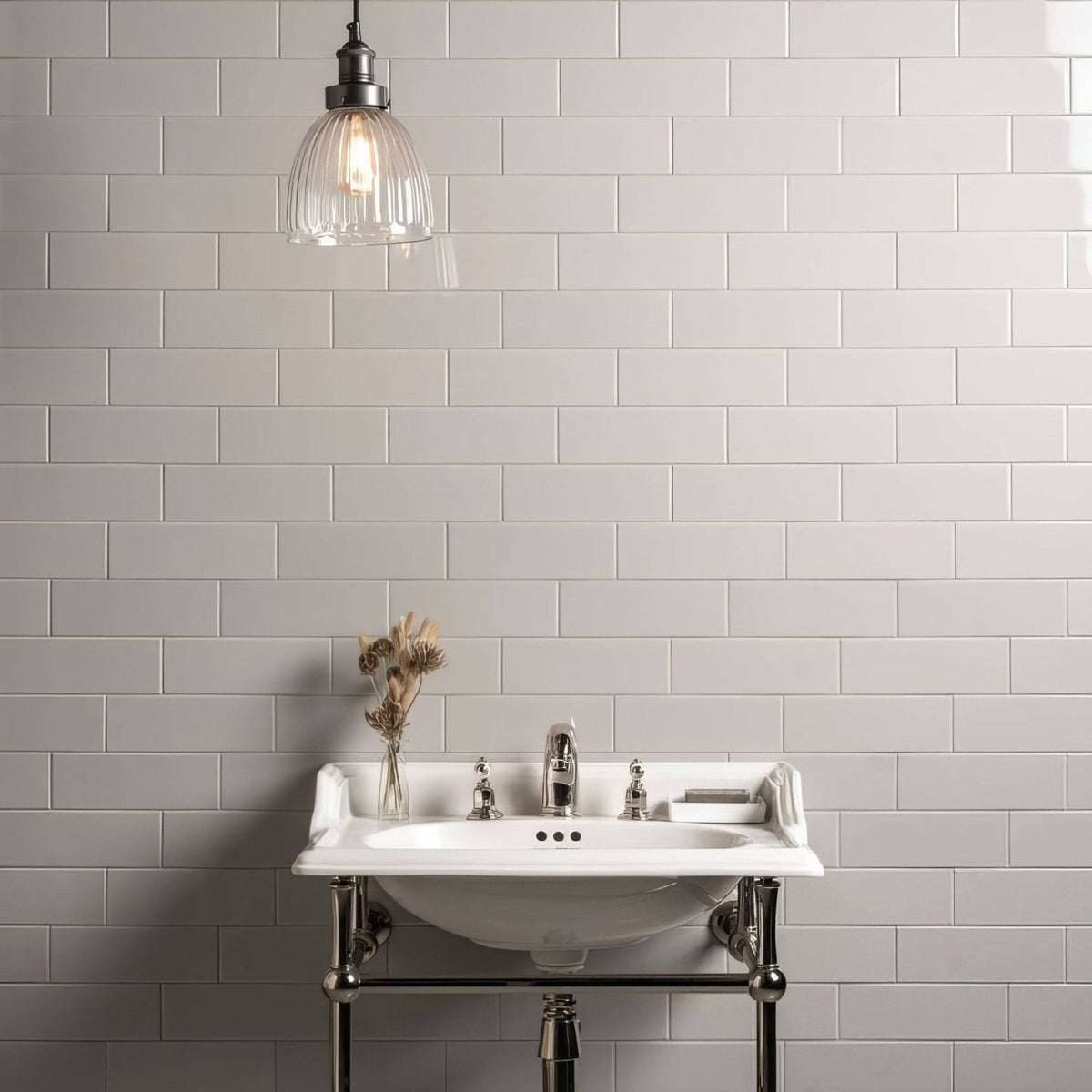 White ceramic pedestal sink with chrome fixtures and matching towel rack in westminster grey large brick setting