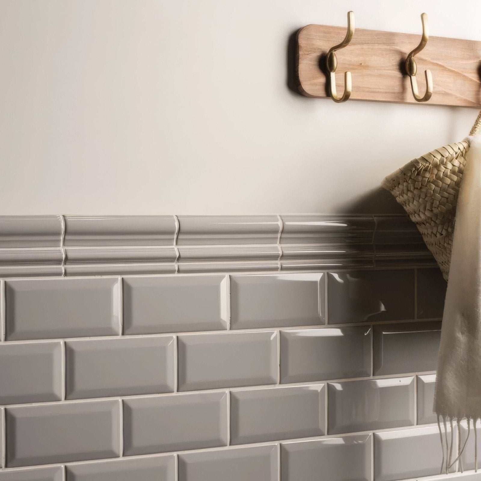 Gray rectangular glossy subway tiles arranged in a classic brick pattern for westminster grey omega moulding