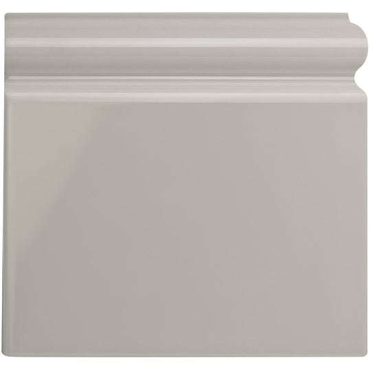 Gray glossy ceramic baseboard with classic slightly curved profile shown from front for Westminster grey skirting right