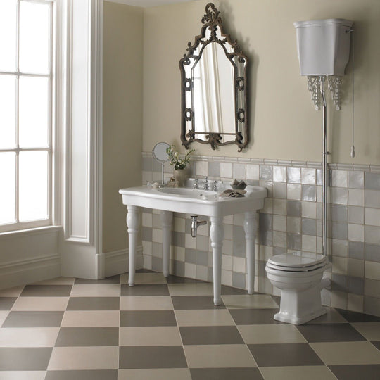 White ochre white ceramic pedestal sink with ornate silver faucet and matching silver legs for bathroom use