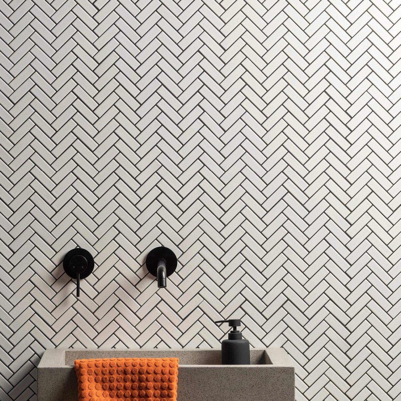 White Satin Chevron white satin chevron mosaic with a sink, black soap dispenser and orange towel