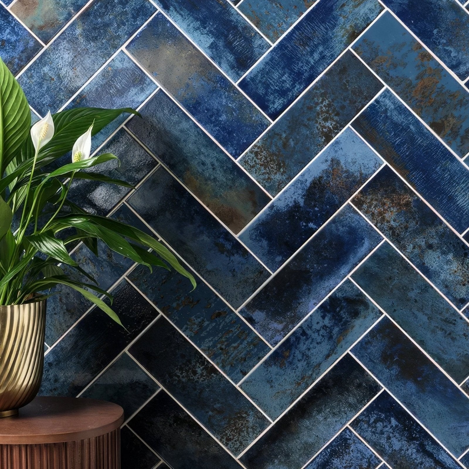 Deep blue wightwick ceramic ink herringbone tiles with textured metallic finish and white grout for wall and floor use