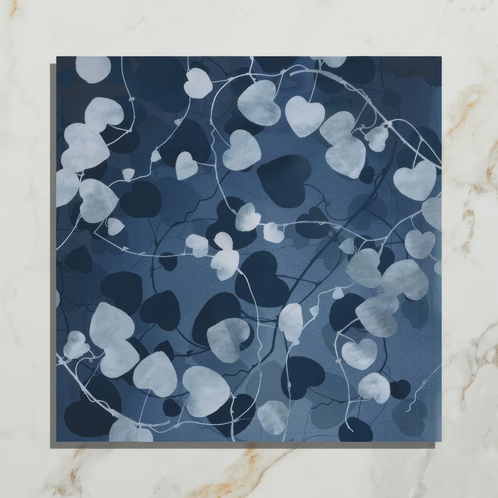 Wild Botanicals Porcelain Blue By Clarissa Hulse dark blue porcelain tile with white heart-shaped leaf silhouettes