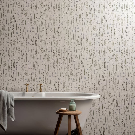 White wildflower violet freestanding bathtub with gold-toned faucets and gray towel draped over the side 60x30cm