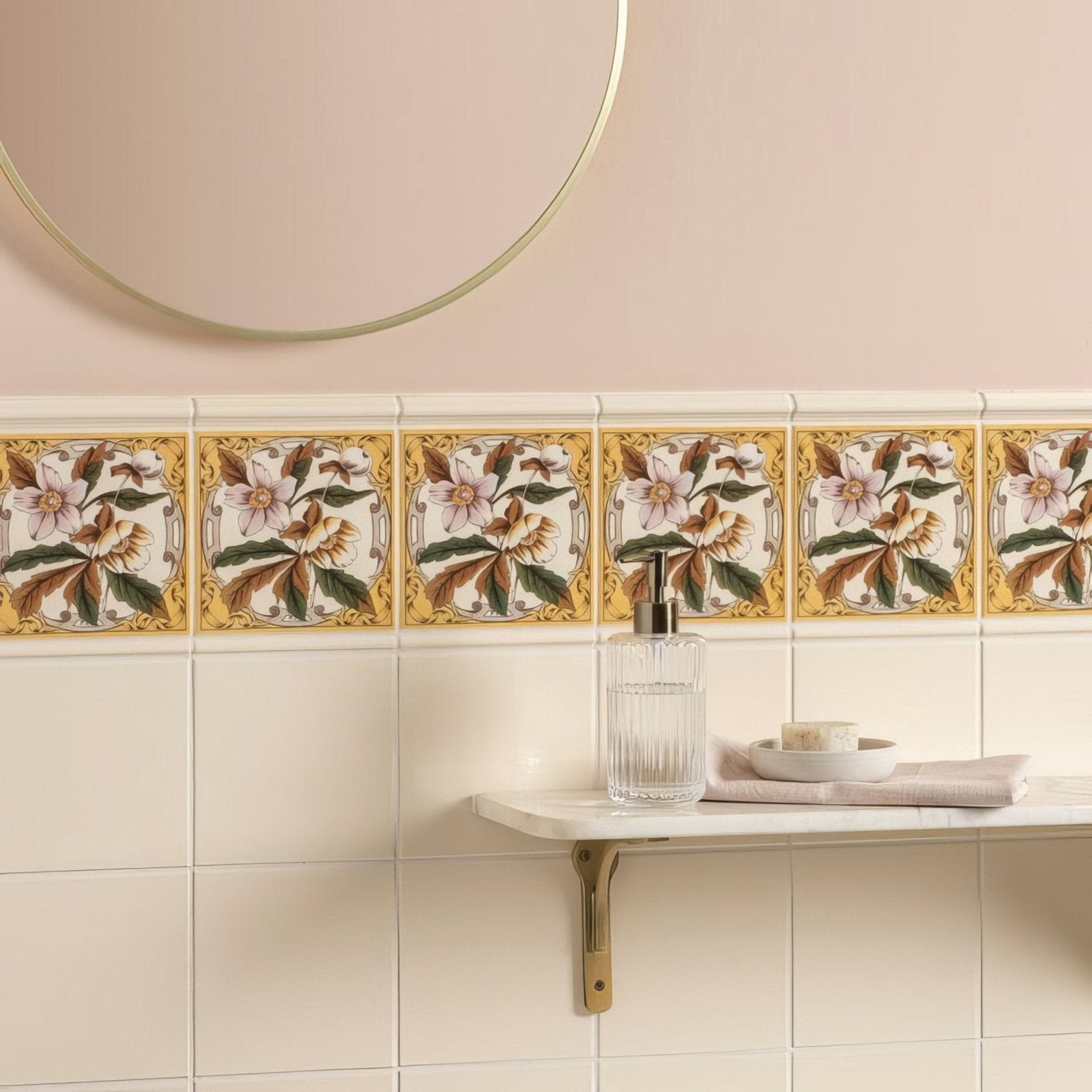 A decorative ceramic tile border featuring intricate pink brown and green floral patterns on a cream background