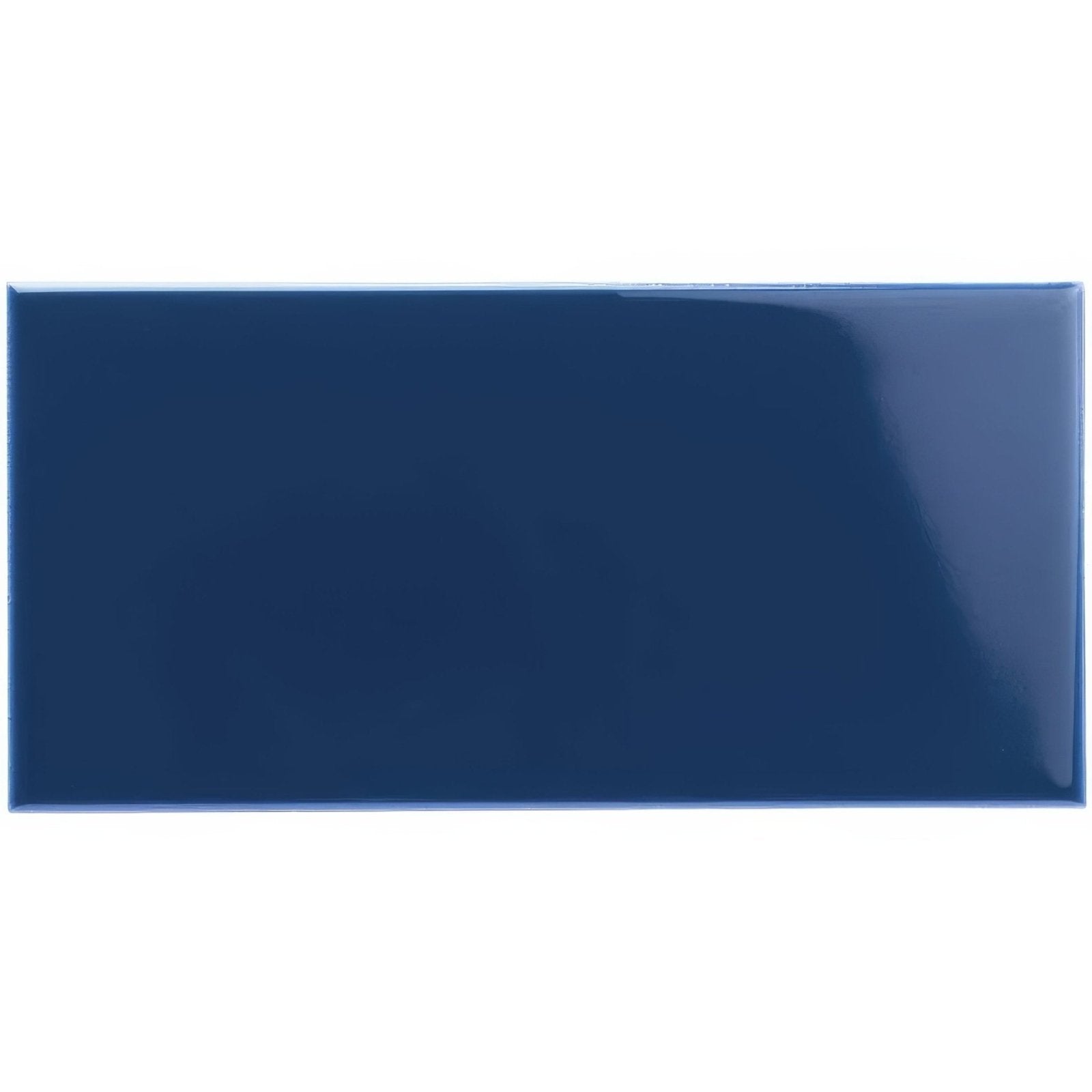 A glossy navy blue rectangular ceramic tile with a smooth reflective surface from the windsor blue half tile collection