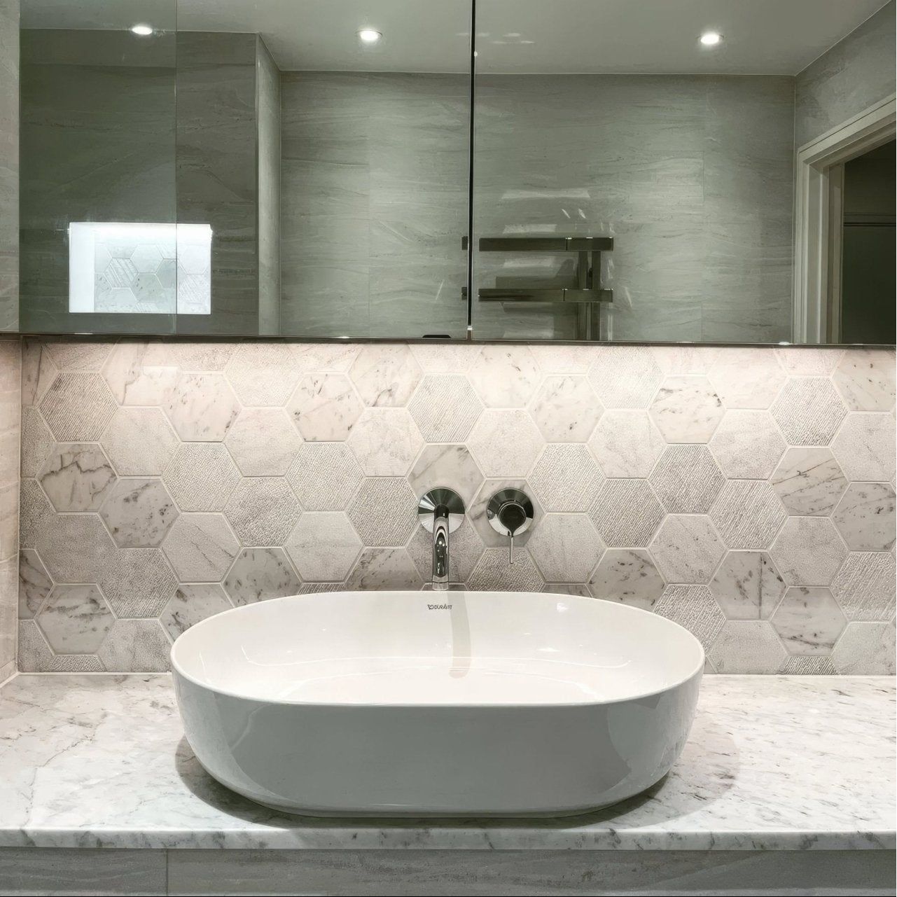 World Hexagon Tex White Mosaic white and grey hexagonal marble mosaic with a white oval vessel sink