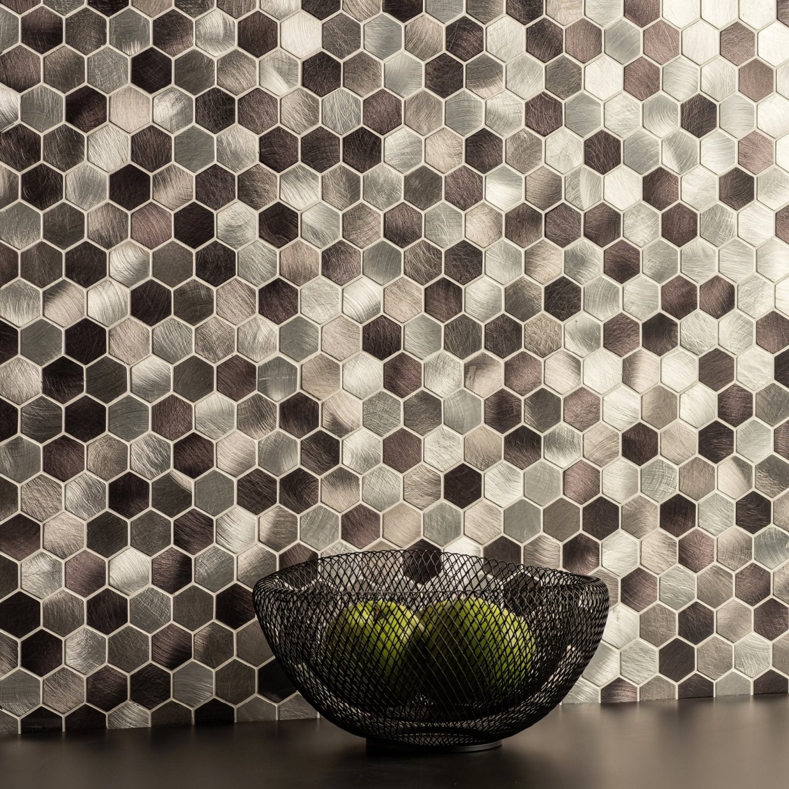 Zenith Silver Aluminium Mosaic silver hexagonal aluminium mosaic with a wire bowl of green apples