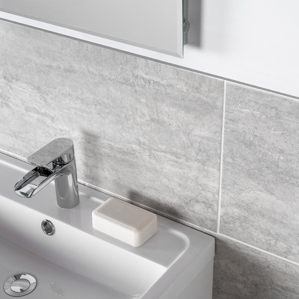 Atrium Marte Gris Tiles grey stone-effect tiles with a chrome tap and white sink
