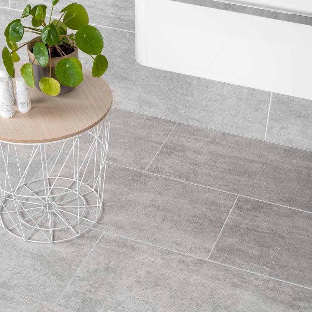 Atrium marte gris gray concrete-effect bathroom floor tiles with subtle texture and clean white grout lines