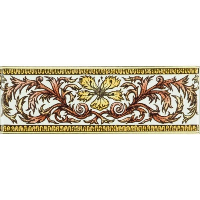 A rectangular ceramic money clip with an ornate gold and rust floral design and a yellow flower on brilliant white