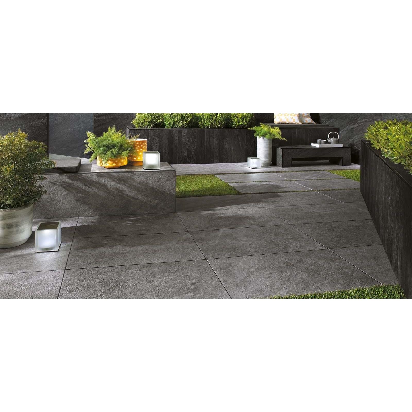 Dark gray stone patio tiles with textured natural finish 20mm from bravestone outdoor collection